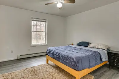 a bedroom with a bed and a ceiling fan at Hike, Ski and Game Spacious Poconos Home with Yard in Tobyhanna