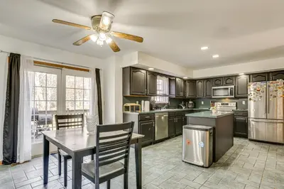 a kitchen with a table and a ceiling fan at Hike, Ski and Game Spacious Poconos Home with Yard in Tobyhanna