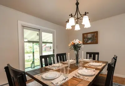 a dining room with a wooden table and chairs at Catskill gem! Four bedroom on 20 quiet acres in Barryville