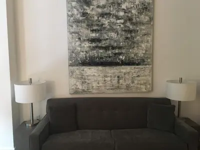 a living room with a couch and two lamps at 1600 Broadway in New York