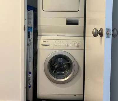 a washer and dryer sitting in a doorway at 1600 Broadway in New York