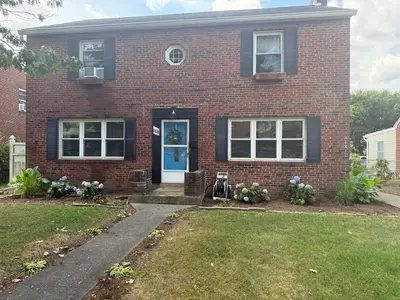 a brick house with a blue door at Happy House in the City in Harrisburg