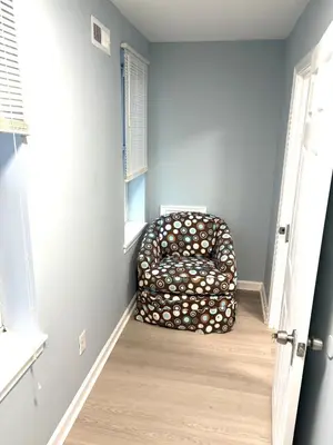 a chair sitting in the corner of a room at 5 bedrooms 2 bathrooms furnished home in Philly near Temple University in Philadelphia