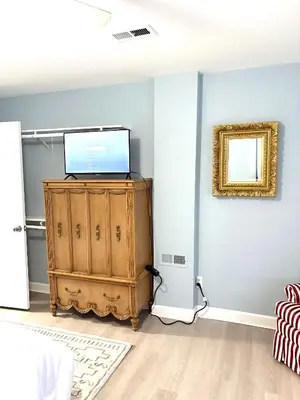 a room with a tv on top of a dresser at 5 bedrooms 2 bathrooms furnished home in Philly near Temple University in Philadelphia