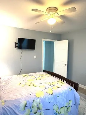a bedroom with a bed with flowers on it at 5 bedrooms 2 bathrooms furnished home in Philly near Temple University in Philadelphia