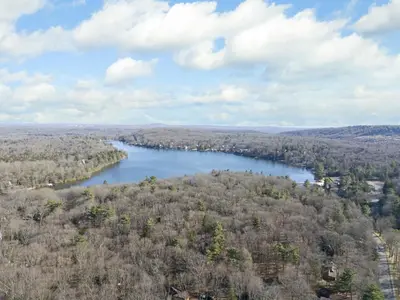 an aerial view of a lake in the woods at Westwood Villas by Coolvacay in Lake Harmony