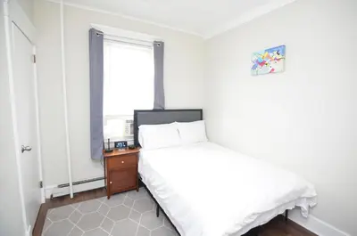 a small bedroom with a bed and a window at Cozy Beds with Parking, Laundry - Near RU, RWJ, NJ Transit in Highland Park
