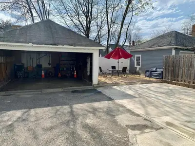 a house with a garage with a red umbrella at Cozy Beds with Parking, Laundry - Near RU, RWJ, NJ Transit in Highland Park