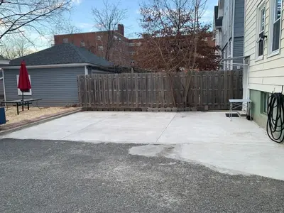a patio in front of a house with a fence at Cozy Beds with Parking, Laundry - Near RU, RWJ, NJ Transit in Highland Park