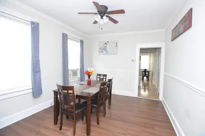 a dining room with a table and chairs and a ceiling fan at Cozy Beds with Parking, Laundry - Near RU, RWJ, NJ Transit in Highland Park