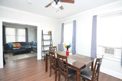 a dining room and living room with a table and chairs at Cozy Beds with Parking, Laundry - Near RU, RWJ, NJ Transit in Highland Park