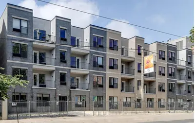 an apartment building with a fence in front of it at Cozy 1BR home inside the Fairmount Square building in Philadelphia