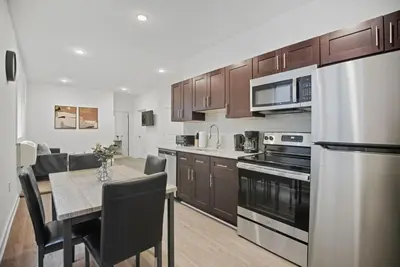 a kitchen with a table and a dining room at Cozy 1BR home inside the Fairmount Square building in Philadelphia