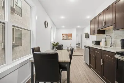 a kitchen and dining room with a table and chairs at Cozy 1BR home inside the Fairmount Square building in Philadelphia