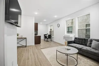 a living room with a couch and a table at Cozy 1BR home inside the Fairmount Square building in Philadelphia