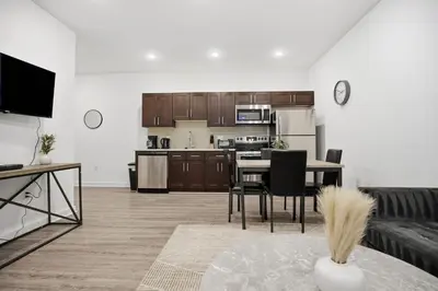 a kitchen and living room with a table and chairs at Modern 1BR1BA unit at Fairmount Square in Philadelphia