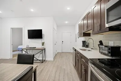 a kitchen with wooden cabinets and a counter top at Modern 1BR1BA unit at Fairmount Square in Philadelphia