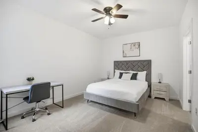 a bedroom with a bed with a ceiling fan and a desk at Modern 1BR1BA unit at Fairmount Square in Philadelphia
