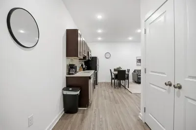 a room with a kitchen with a mirror and a door at Modern 1BR1BA unit at Fairmount Square in Philadelphia