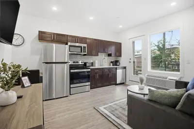a living room with a couch and a kitchen at Bright 1BR unit in the Fairmount Square building in Philadelphia