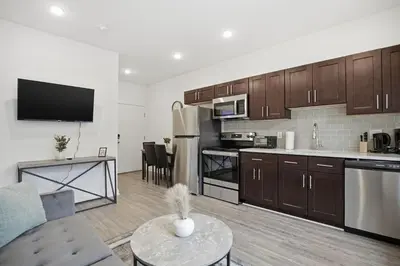a kitchen and living room with a couch and a table at Bright 1BR unit in the Fairmount Square building in Philadelphia