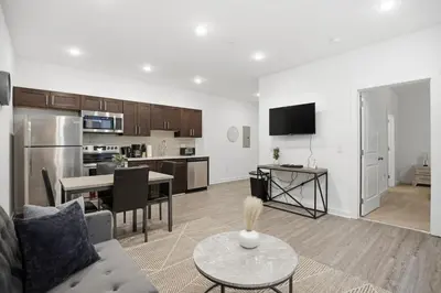 a living room and kitchen with a couch and a table at Contemporary 1BR inside Fairmount Square in Philadelphia