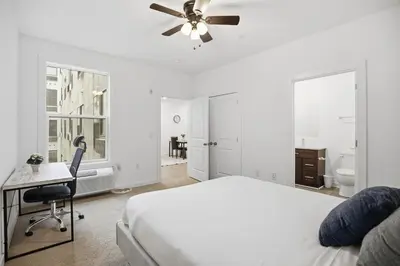 a bedroom with a bed and a desk and a ceiling fan at Contemporary 1BR inside Fairmount Square in Philadelphia
