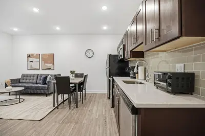 a kitchen and living room with a couch and a table at Contemporary 1BR inside Fairmount Square in Philadelphia