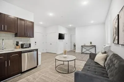 a living room and kitchen with a couch and a table at Refreshed 1BR1BA in Fairmount Square in Philadelphia