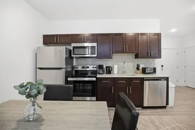 a kitchen with stainless steel appliances and wooden cabinets at Refreshed 1BR1BA in Fairmount Square in Philadelphia