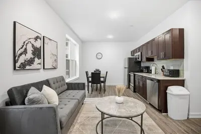 a living room with a couch and a kitchen at Refreshed 1BR1BA in Fairmount Square in Philadelphia