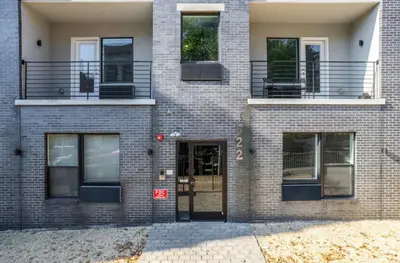 a brick building with a door and a balcony at Refreshed 1BR1BA in Fairmount Square in Philadelphia
