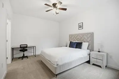 a white bedroom with a bed and a ceiling fan at Cozy and bright 1BR located in Fairmount Square in Philadelphia