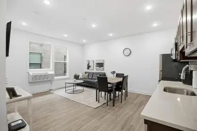 a kitchen and living room with a table and a couch at Cozy and bright 1BR located in Fairmount Square in Philadelphia