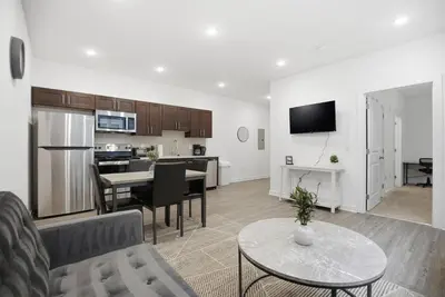 a living room and kitchen with a couch and a table at Cozy and bright 1BR located in Fairmount Square in Philadelphia