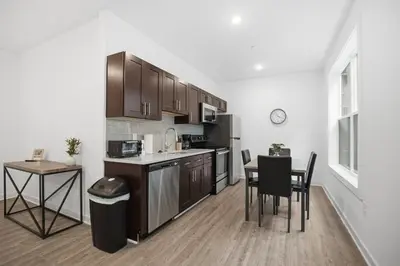 a kitchen with a table and chairs and a counter top at Simple, modern 1BR in Fairmount Square in Philadelphia