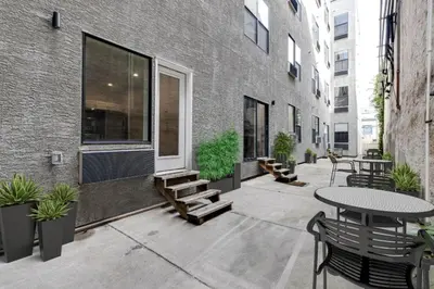 a patio with a table and benches and a building at Simple, modern 1BR in Fairmount Square in Philadelphia