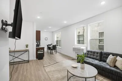a living room with a couch and a table at Simple, modern 1BR in Fairmount Square in Philadelphia