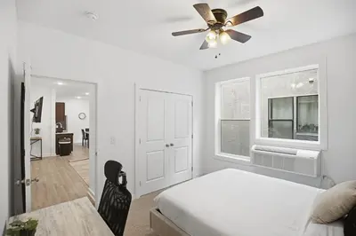 a bedroom with a bed and a ceiling fan at Simple, modern 1BR in Fairmount Square in Philadelphia
