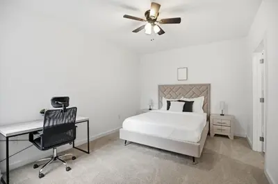 a bedroom with a bed and a desk and a ceiling fan at Attractive 1BR1BA apartment at Fairmount Square in Philadelphia
