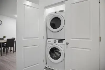 a white laundry room with a washer and dryer at Comfortable updated 1BR in Fairmount Square in Philadelphia