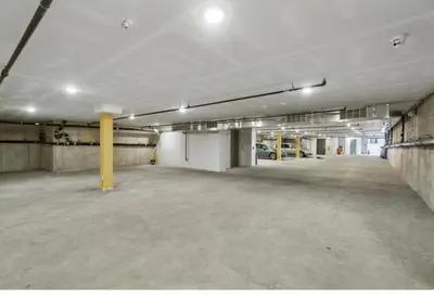 an empty parking garage with cars parked in it at Comfortable updated 1BR in Fairmount Square in Philadelphia