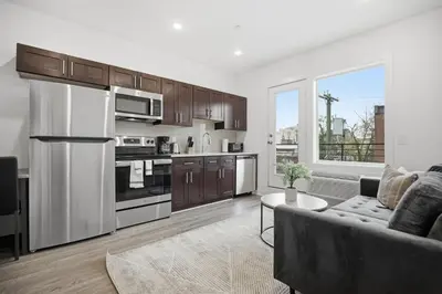 a living room with a couch and a kitchen at Comfortable updated 1BR in Fairmount Square in Philadelphia