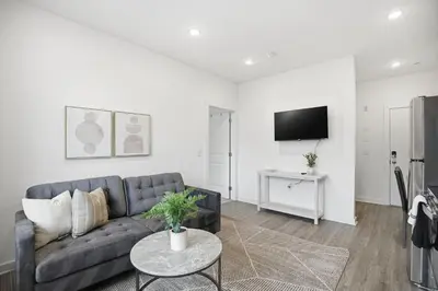 a living room with a couch and a tv at Comfortable updated 1BR in Fairmount Square in Philadelphia