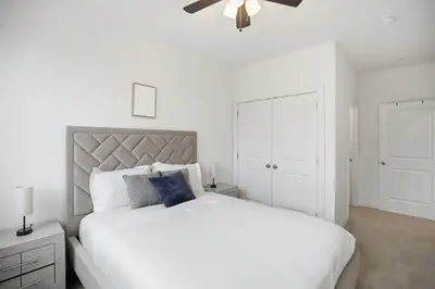 a bedroom with a white bed and a ceiling fan at Comfortable updated 1BR in Fairmount Square in Philadelphia