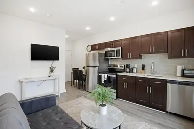 a living room with a couch and a kitchen at Comfortable updated 1BR in Fairmount Square in Philadelphia