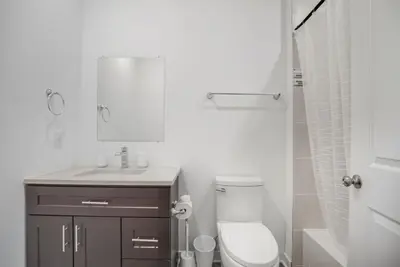 a bathroom with a toilet and a sink and a mirror at Bright and cozy 1BR inside Fairmount Square in Philadelphia