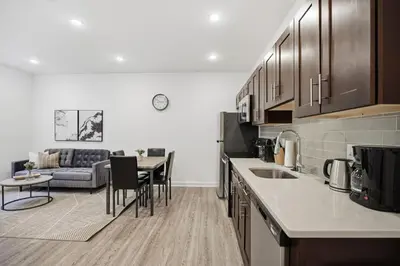 a kitchen and living room with a couch and a table at Bright and cozy 1BR inside Fairmount Square in Philadelphia