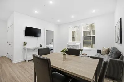 a dining room and living room with a table and chairs at Bright and cozy 1BR inside Fairmount Square in Philadelphia