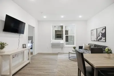 a living room with a couch and a tv at Bright and cozy 1BR inside Fairmount Square in Philadelphia